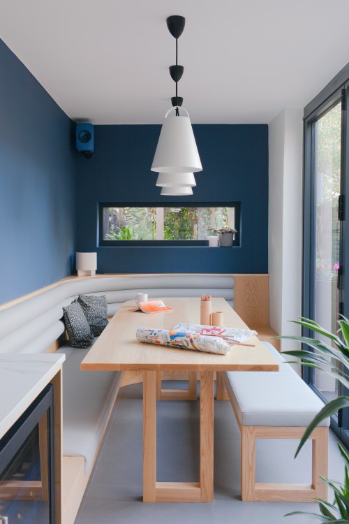 dining table dining bench banquette picture window bi fold doors blue walls tiled floor grey tiles vegan leather